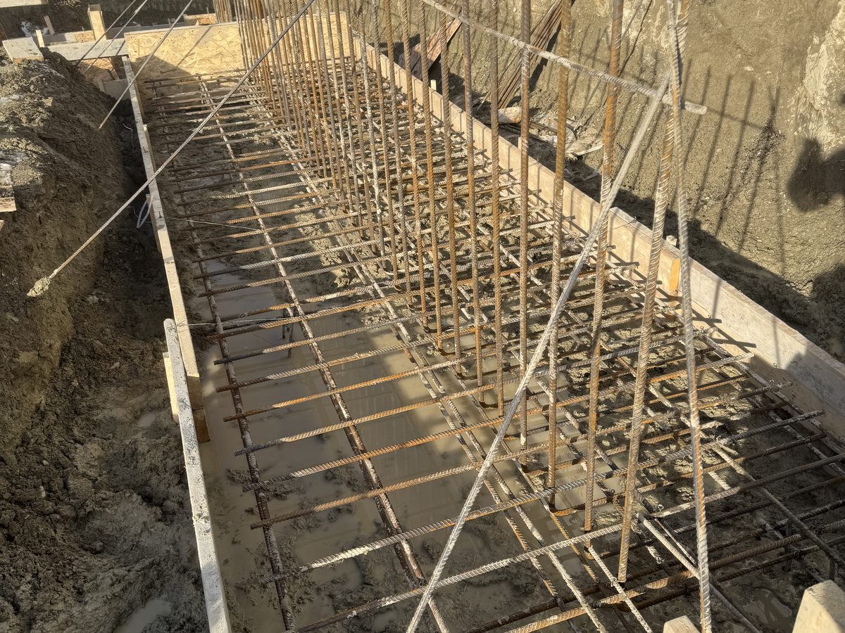 Rebar placed in footing and pad forms ahead of the pour