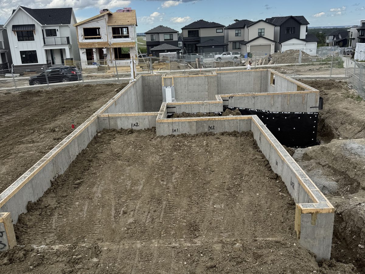 Clean stripped foundation walls on a single-family infill lot