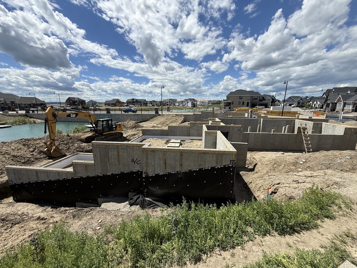 Stripped walkout foundation with step-down walls and damp-proofing applied